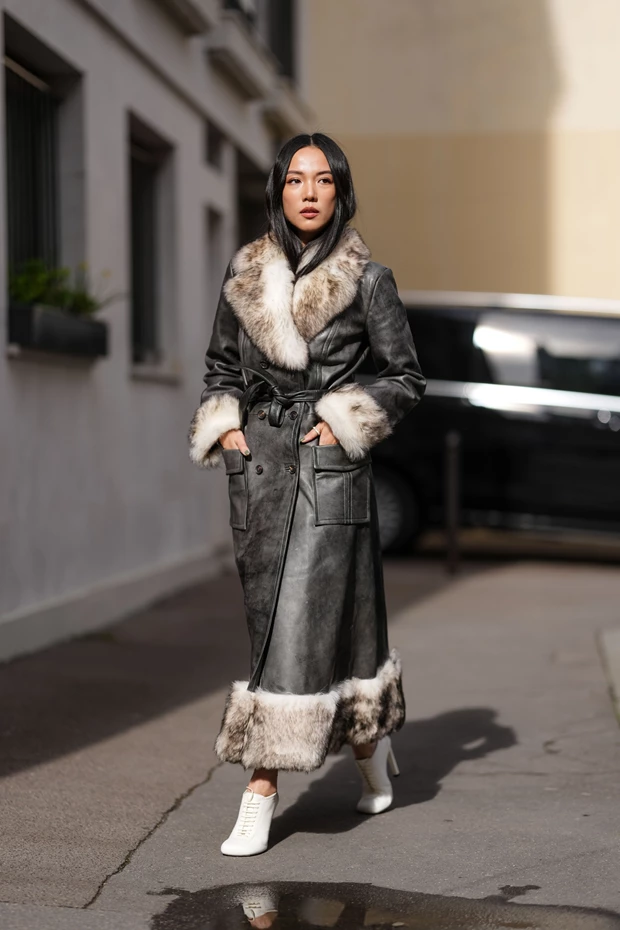 Μακρύ, κομψό δερμάτινο παλτό σε σκούρο γκρι χρώμα με εντυπωσιακό γούνινο γιακά και λεπτομέρειες από γούνα στο τελείωμα και στις μανσέτες.