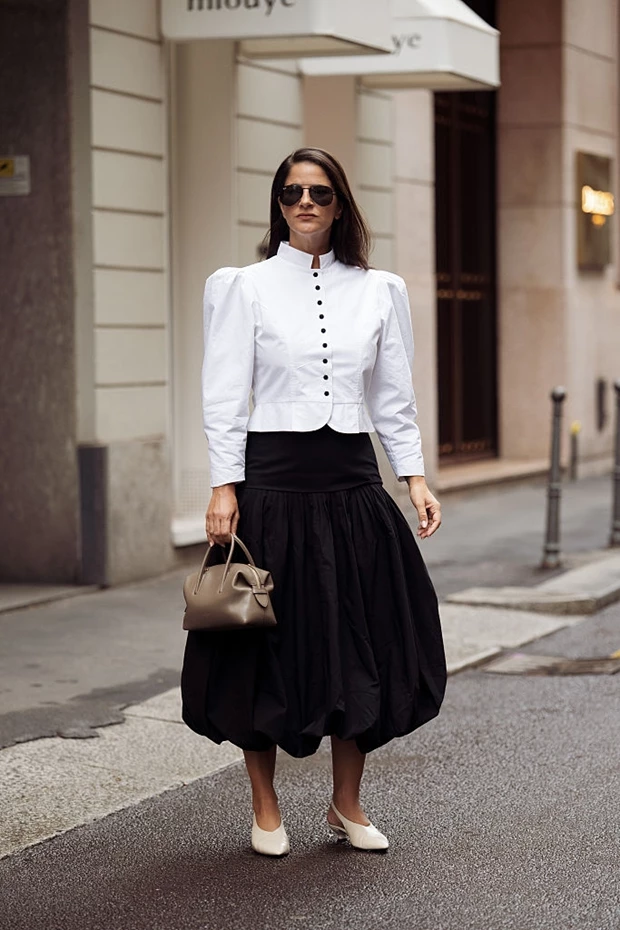 Minimal chic εμφάνιση με λευκά flat παπούτσια, μαύρη φούστα και λευκό πουκάμισο