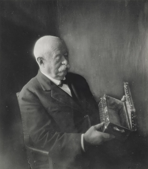 Georges Vuitton examining a Malle Fleurs in Monogram canvas, circa 1930 (gelatin silver print).